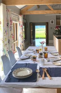 a long table with a blue and white table cloth at Stunning 'Room with a view' in Banbury