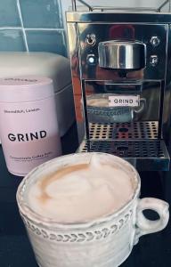 a cup of coffee sitting next to a coffee maker at Luxury & comfort in the Cotswolds in Banbury