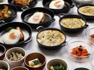 a bunch of bowls of food on a table at Dormy Inn Oita in Oita