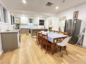 a kitchen and dining room with a table and chairs at Charming House; Walk to Beach & Shops in Rosebud
