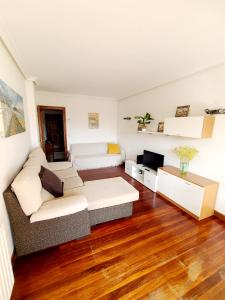 a living room with a couch and a table at Apartamento Pilartxo Zarautz in Zarautz
