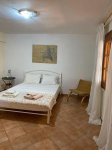 a bedroom with a bed with two towels on it at Agia Paraskevi Villa Olive in Mákri