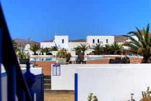 a view of a resort with a pool and buildings at Casa Nancy in Puerto Calero