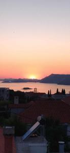 a sunset over a city with a view of the water at Antonny apartment in Zvekovica +7 photos
