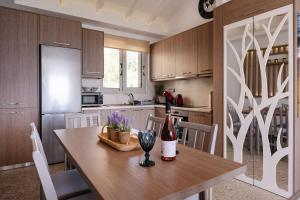 a kitchen with a table with a bottle of wine at Addimare Sea View Villa, and Events Venue in Alykes