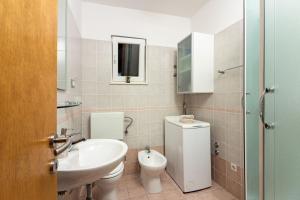 a bathroom with a sink and a toilet at Apartment Mandalina House in Stari Grad +27 photos