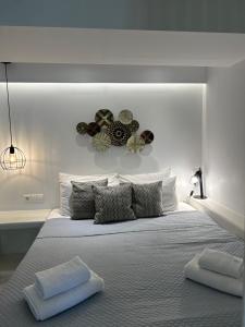 a bedroom with a large bed with two towels on it at Sea View Apartments & Studios in Agia Anna Naxos