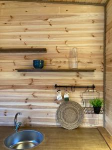 a bathroom with a sink and a wooden wall at Baraqa hoolbox in Fethiye