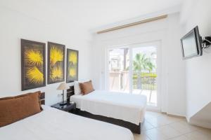 a bedroom with two beds and a window at Apollonium Bozbuk in Akbük +19 photos