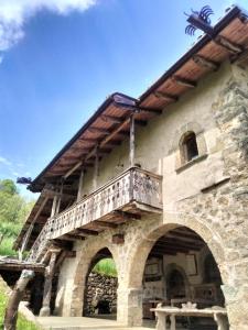 a building with a balcony on top of it at DOSSENA Dimora Storica Al Lac Conte Tomaselli in Madonna della Costa