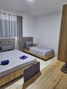two beds in a room with two bedsitures at Vila Gashi in Durrës