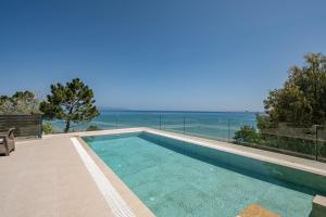 a swimming pool with a view of the ocean at Addimare Sea View Villa, and Events Venue in Alykes