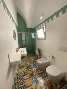a bathroom with a white toilet and a sink and a toilet at Historic Room in Noha