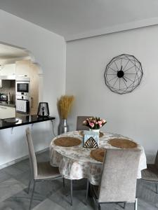 a kitchen and dining room with a table and chairs at Seaside condo with pool, Marbella in Estepona