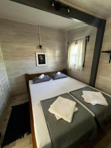 a bedroom with a large bed with two pillows at Chatka Daisy A,B in Pakoštane