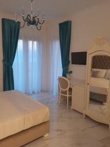 a bedroom with a bed and a desk with a television at La Vigna del Vento in Casola di Napoli +61 photos