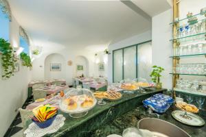 a buffet with a lot of food on a table at Hotel Villa Giulia in Tortona