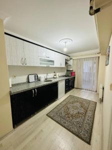 a kitchen with a counter and a rug on the floor at Ak Home Dublex - apartment in Çanakkale
