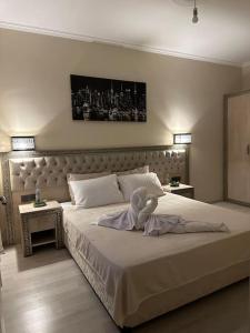 a bedroom with a large bed with a stuffed animal on it at Ak Home Dublex - apartment in Çanakkale