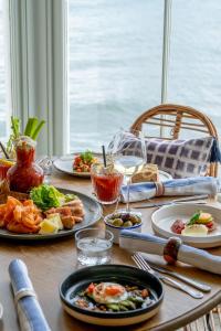 a wooden table with plates of food on it at The Godolphin Hotel in Marazion