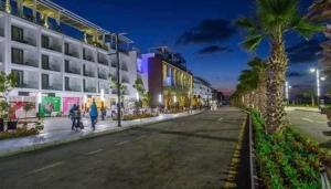 a street in front of a building with a palm tree at portosaid chelat-portsaid in `Ezbet Shalabi el-Rûdi
