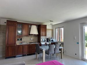 a kitchen with a table and chairs and a kitchen with a stove at Sole in Verbania
