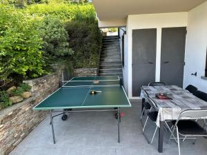 una mesa de ping pong con una pelota de ping pong en el patio en Sole, en Verbania