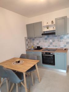 a kitchen with a wooden table and a table and chairs at Povljana Maris in Povljana +7 photos