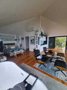 a large living room with chairs and a couch at The Deck House Wye River in Wye River