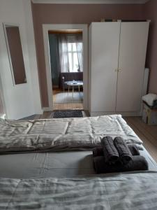 a bedroom with a large bed with two towels on it at 1 bedroom apartment, whole flat in Arvika