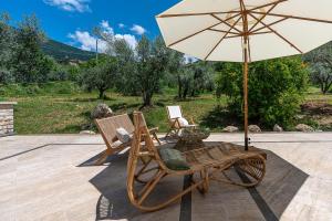 two chairs and an umbrella on a patio at Al Piglio Maison de Charme in Piglio