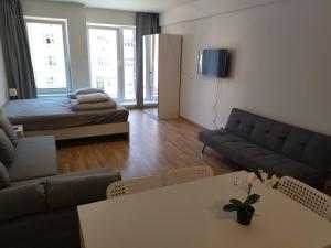 a living room with a couch and a table at Brand new two room apartment #34 with free secure parking in the center in Prague