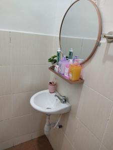 a bathroom with a sink and a mirror at Wan K Homestay Gua Musang in Gua Musang