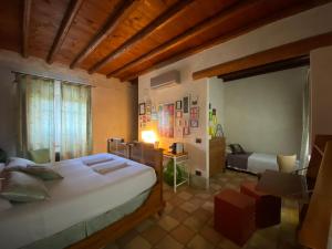 a bedroom with two beds and a chair in a room at B&B Molino2Rosso in Verona