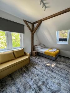 a bedroom with two beds and two windows at HORIZON in Ustka