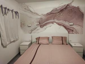 a bedroom with a bed with a painting on the wall at Apartman Mala Lalina in Komin
