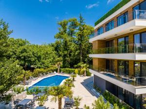 an exterior view of a building with a swimming pool at Touch Hotel in Lozenets