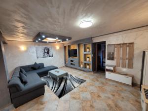 a living room with a couch and a table at Apartments Dragon in Umag
