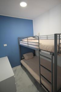 a bunk bed room with two bunk beds and a table at Las Americas - 2 bedrooms - Flayla-A in Arona +26 photos