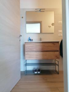 a bathroom with a sink and a mirror at Colori nel Parco 2 in Cesiomaggiore +32 photos