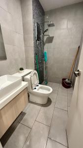 a bathroom with a toilet and a sink and a shower at The Shore-Sweet Home B16-02 in Kota Kinabalu