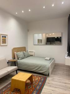a bedroom with a bed and a couch at Cozy near the Barcelona Camp Nou Stadium in Barcelona