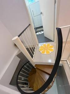 a spiral staircase with a chair with a flower on it at The Van Gogh Loft at Selesa Hillhomes in Bukit Tinggi