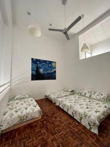 a room with two beds and a ceiling fan at The Van Gogh Loft at Selesa Hillhomes in Bukit Tinggi +11 photos
