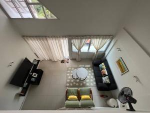 a living room with two green chairs and a window at The Van Gogh Loft 梵高小栈 at Selesa Hillhomes in Bukit Tinggi