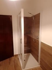a shower with a glass door in a bathroom at Casa Carducci Affittacamere in Monteleto +22 photos