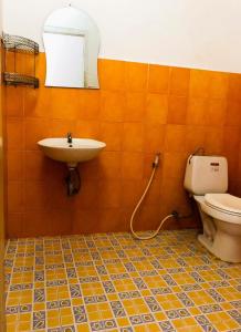 a bathroom with a sink and a toilet at Vernice Backpacker Hostel in Vientiane
