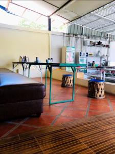a glass table in a room with a couch at Vernice Backpacker Hostel in Vientiane