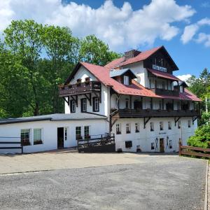 ein großes weißes Gebäude mit rotem Dach in der Unterkunft Villa Fortuna in Duszniki-Zdrój