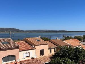 a group of houses with the water in the background at Charmant duplex vue mer et étangs ! Clim / Parking in Frontignan